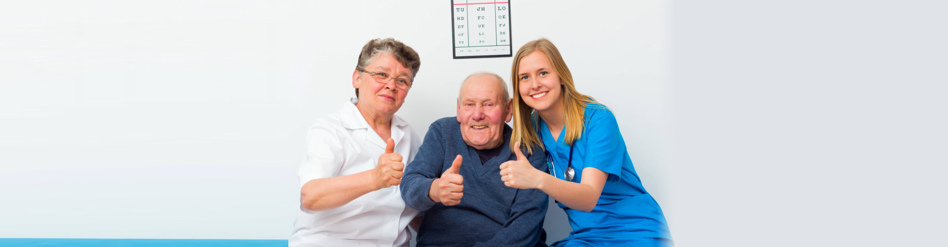 healthcare staff with their patient showing thumbs up